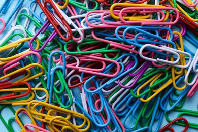 Heap of different paper clips as background, top view Photo of Heap of different paper clips as background, top view