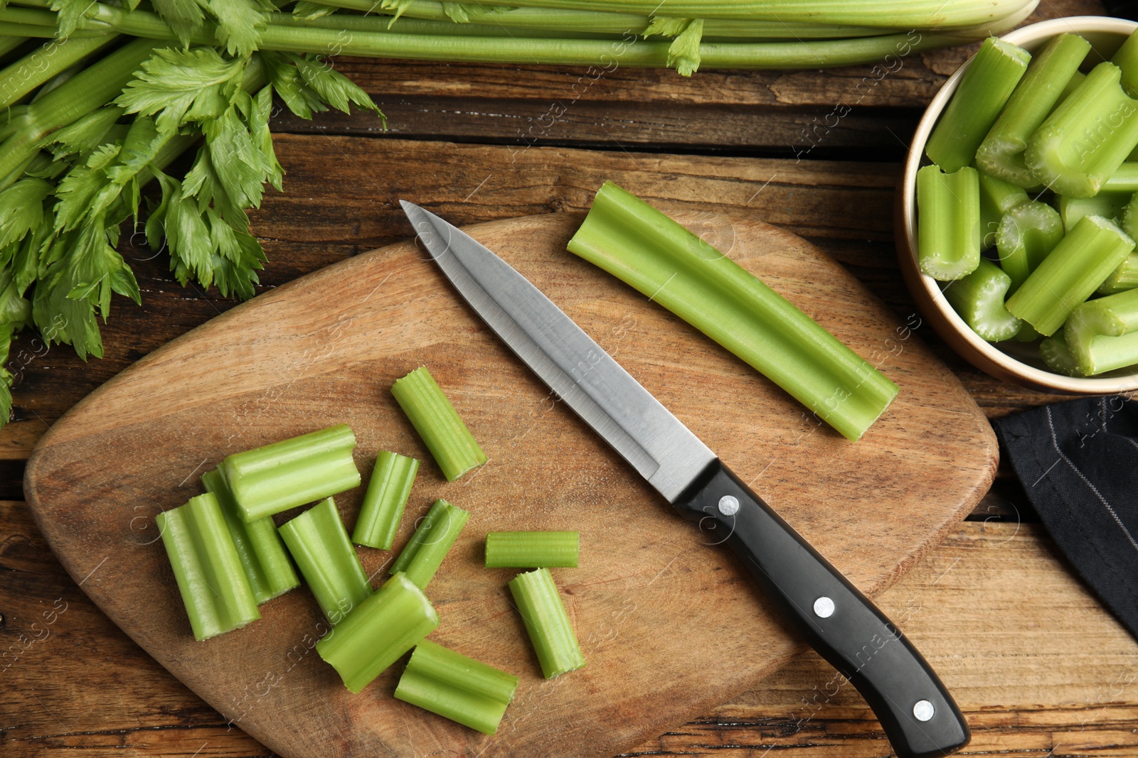 Fresh ripe green celery on wooden table, flat lay Photo of Fresh ripe green celery on wooden table, flat lay