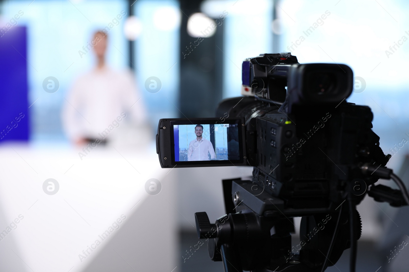 Presenter working in studio, focus on video camera Photo of Presenter working in studio, focus on video camera