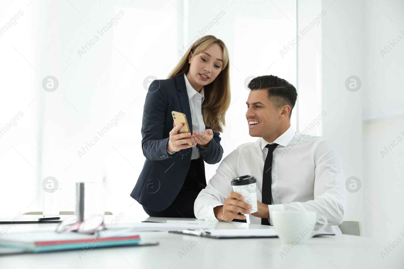 Photo of Office employees talking at workplace during break