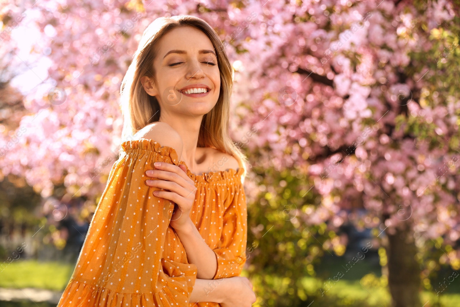 Young woman wearing stylish outfit in park on spring day. Fashionable look Photo of Young woman wearing stylish outfit in park on spring day. Fashionable look