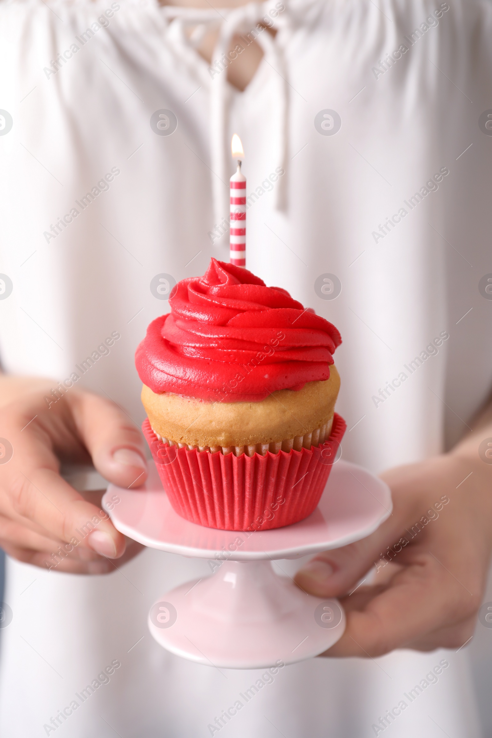 Woman holding stand with birthday cupcake, closeup Photo of Woman holding stand with birthday cupcake, closeup