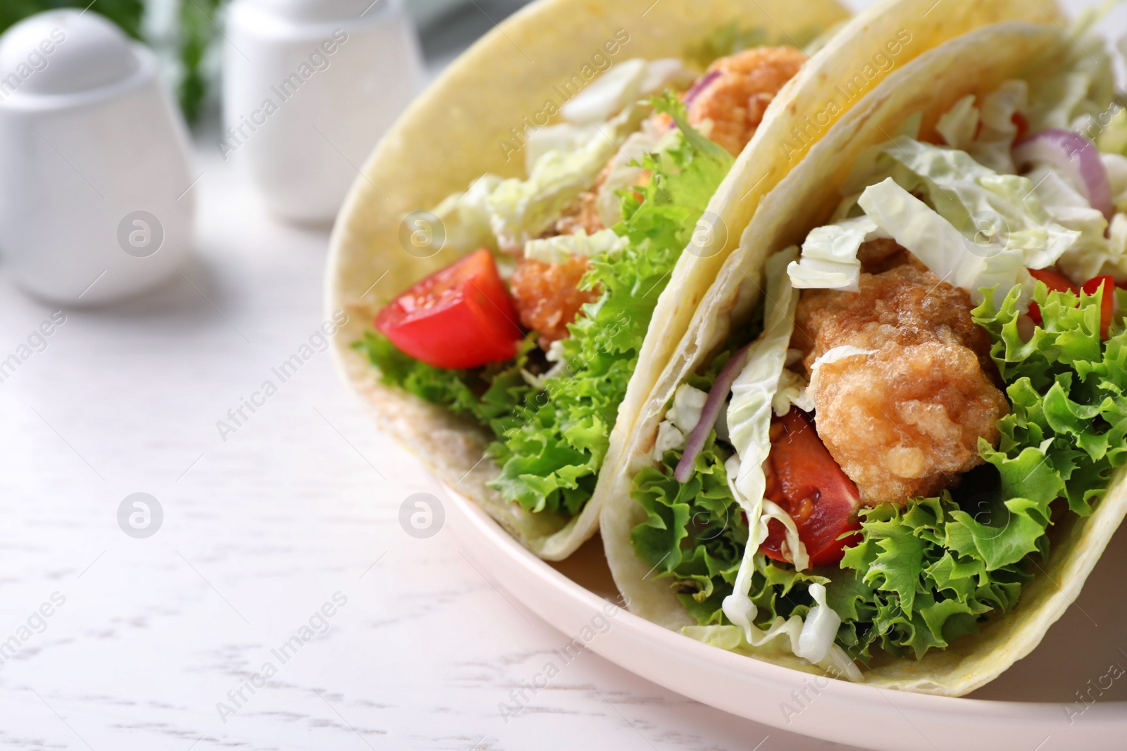 Yummy fish tacos served on white wooden table, closeup Photo of Yummy fish tacos served on white wooden table, closeup