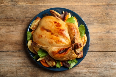 Delicious cooked turkey with garnish on wooden table, top view. Thanksgiving Day celebration Photo of Delicious cooked turkey with garnish on wooden table, top view. Thanksgiving Day celebration