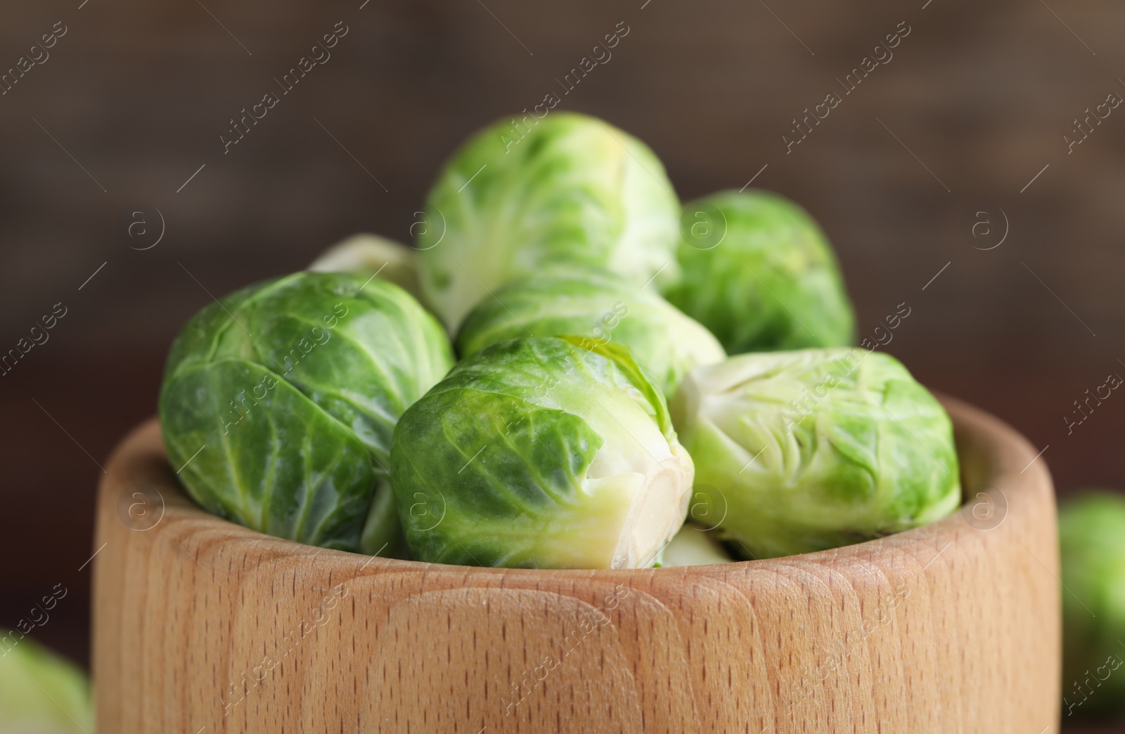 Fresh Brussels sprouts in wooden bowl, closeup Photo of Fresh Brussels sprouts in wooden bowl, closeup