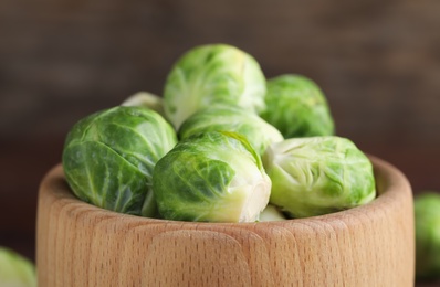 Fresh Brussels sprouts in wooden bowl, closeup Photo of Fresh Brussels sprouts in wooden bowl, closeup