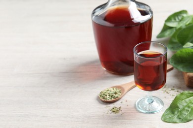 Broadleaf plantain tincture on white wooden table, space for text Photo of Broadleaf plantain tincture on white wooden table, space for text