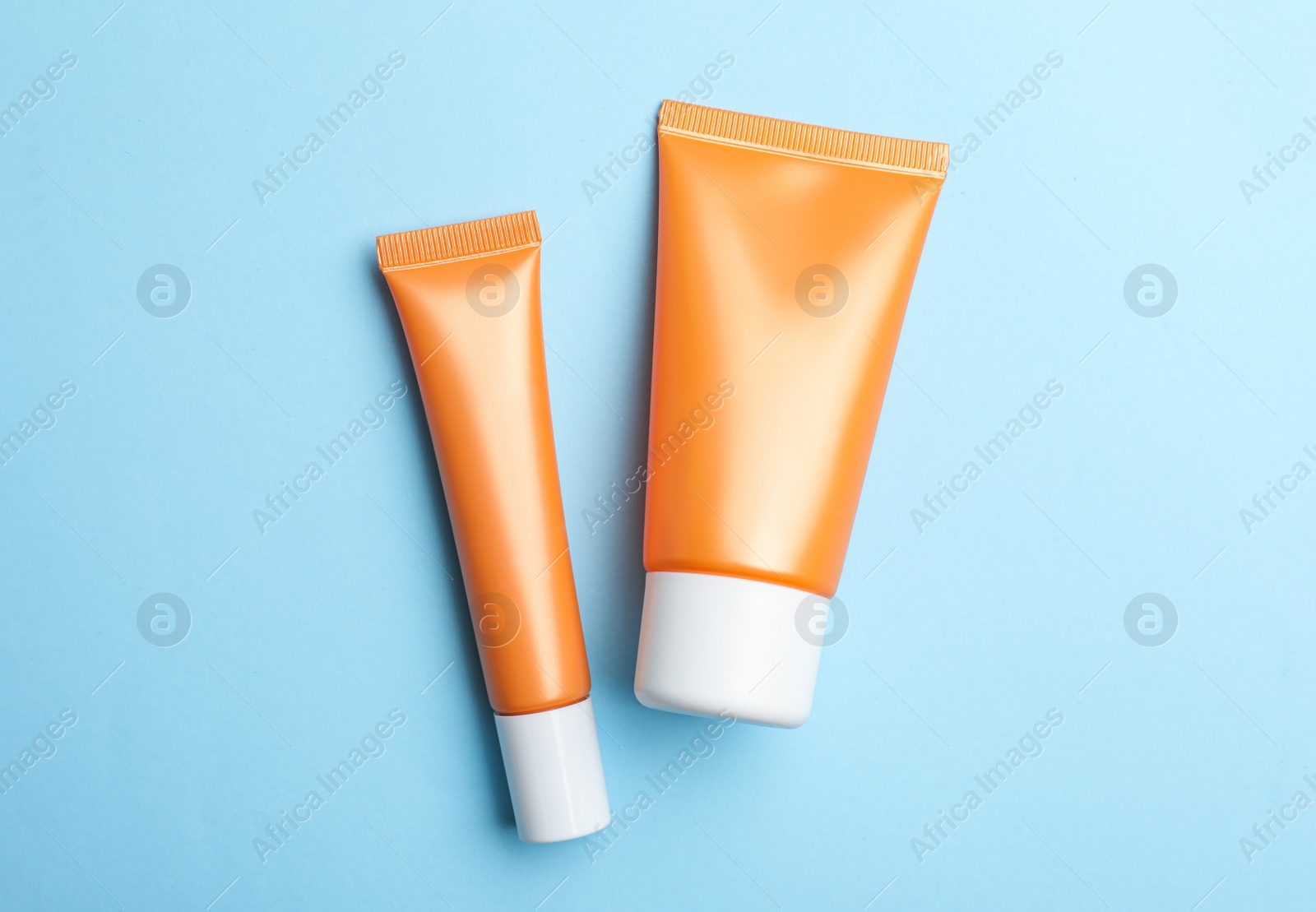 Set of luxury cosmetic products on light blue background, flat lay Photo of Set of luxury cosmetic products on light blue background, flat lay