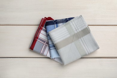 Photo of Stylish handkerchiefs on white wooden table, flat lay