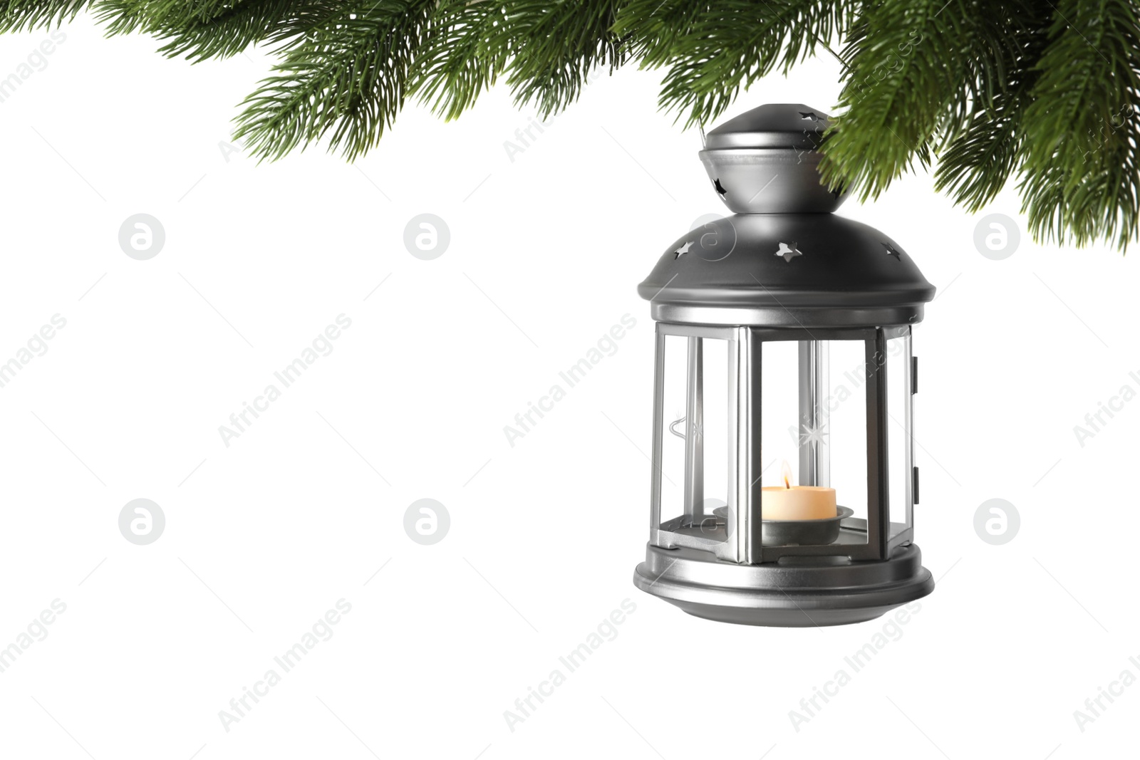Christmas lantern with candle hanging on snowy fir tree branch against white background Photo of Christmas lantern with candle hanging on snowy fir tree branch against white background