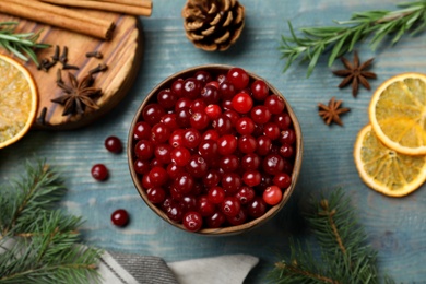 Flat lay composition with fresh ripe cranberries on blue wooden table Photo of Flat lay composition with fresh ripe cranberries on blue wooden table