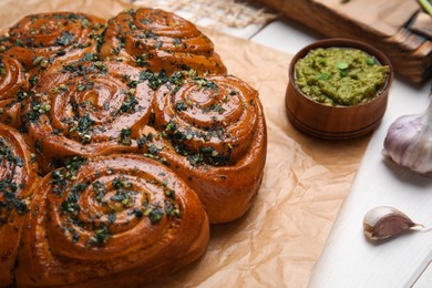 Traditional pampushka rolls with garlic and herbs on table, closeup Photo of Traditional pampushka rolls with garlic and herbs on table, closeup