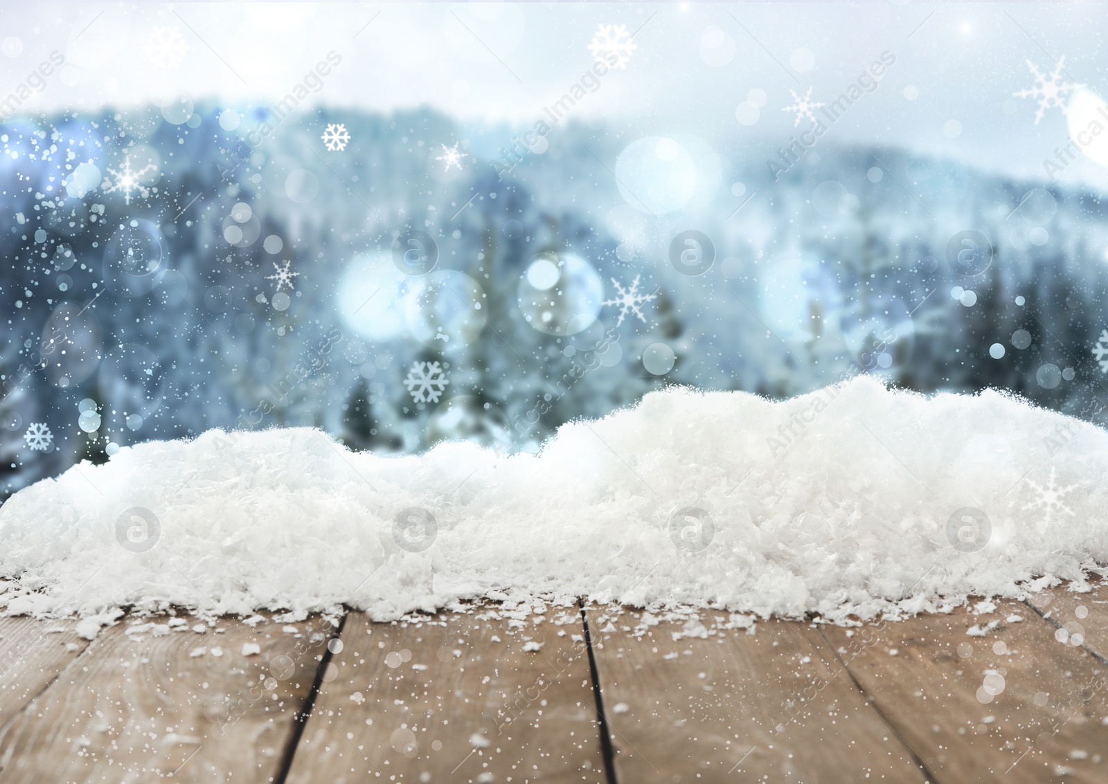 Image of Wooden board with snow and blurred forest on background. Christmas time