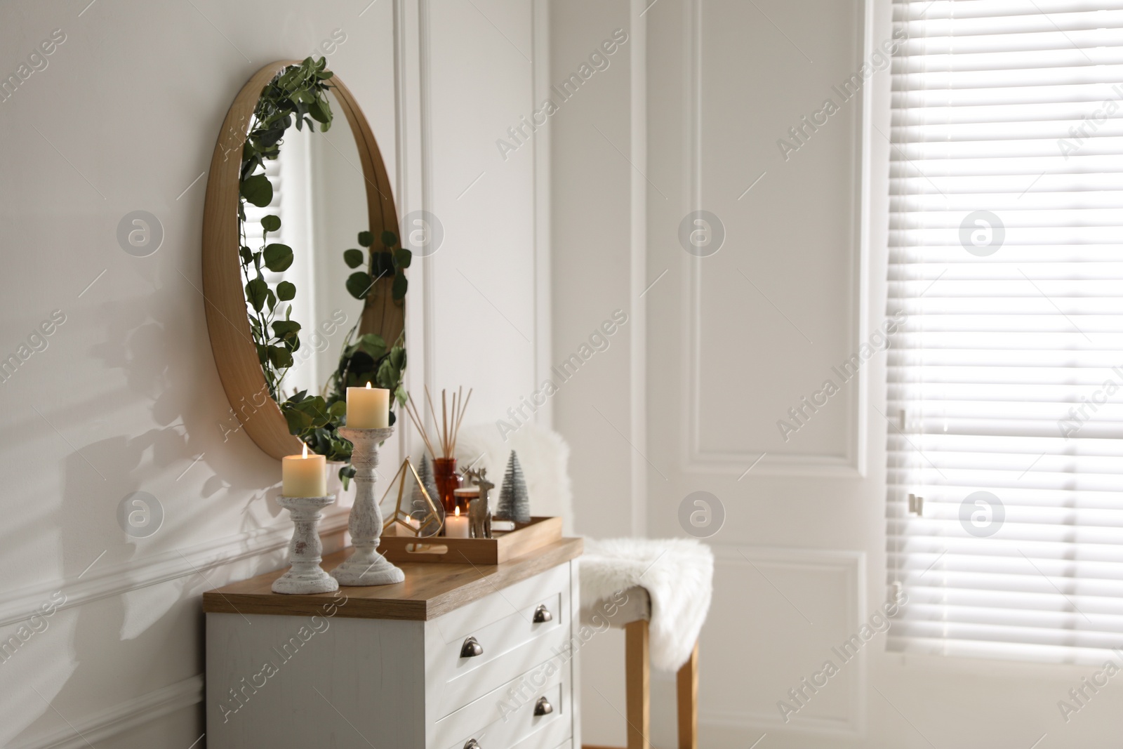 Modern room interior with chest of drawers and mirror on white wall Photo of Modern room interior with chest of drawers and mirror on white wall