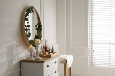 Modern room interior with chest of drawers and mirror on white wall Photo of Modern room interior with chest of drawers and mirror on white wall