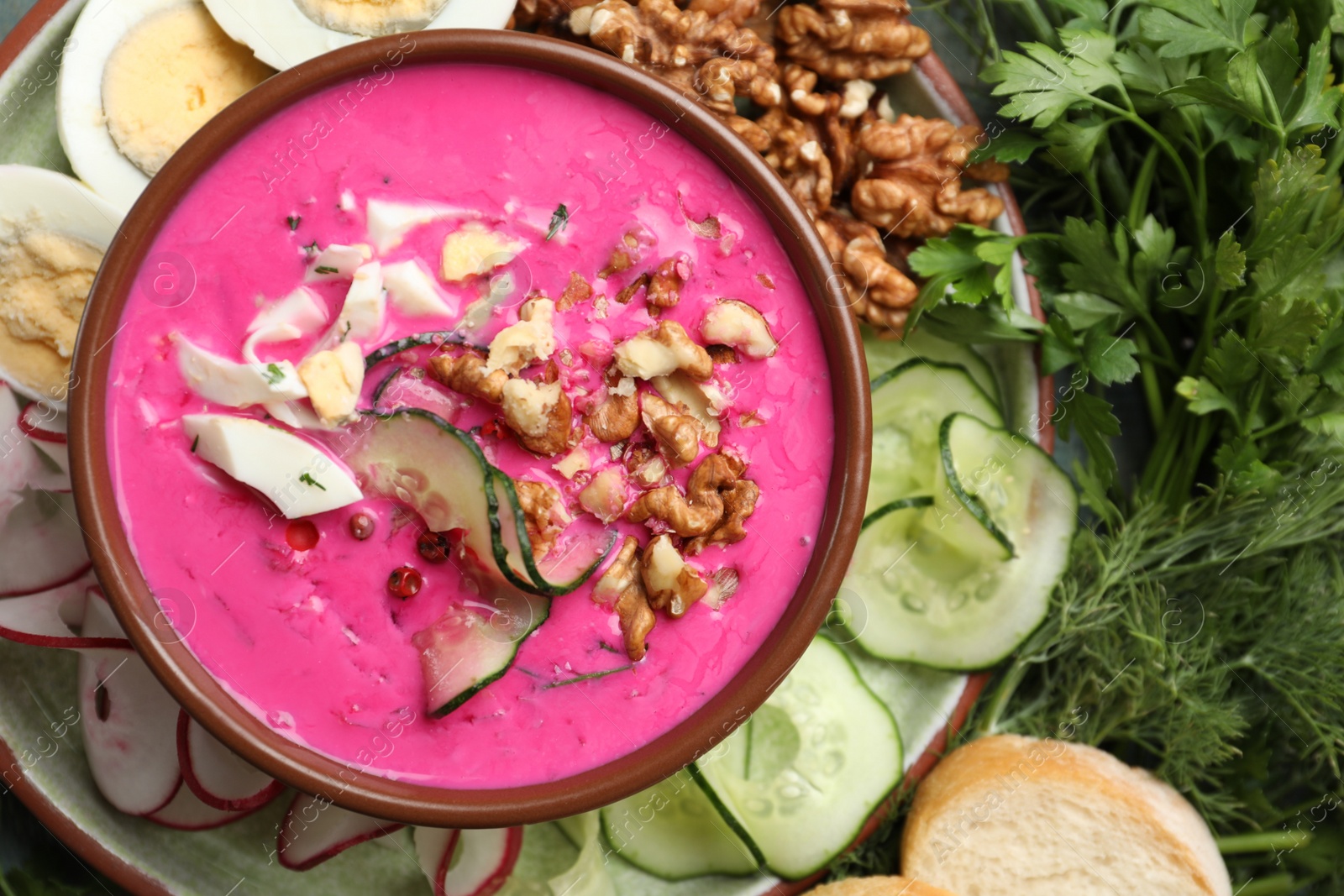 Delicious cold summer beet soup in bowl, flat lay Photo of Delicious cold summer beet soup in bowl, flat lay