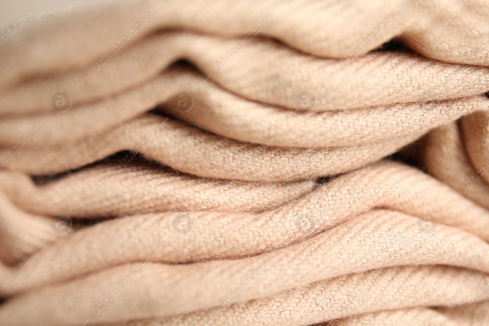 Folded beige soft cashmere fabric, closeup view Photo of Folded beige soft cashmere fabric, closeup view