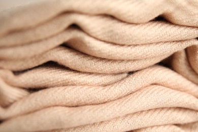 Folded beige soft cashmere fabric, closeup view Photo of Folded beige soft cashmere fabric, closeup view
