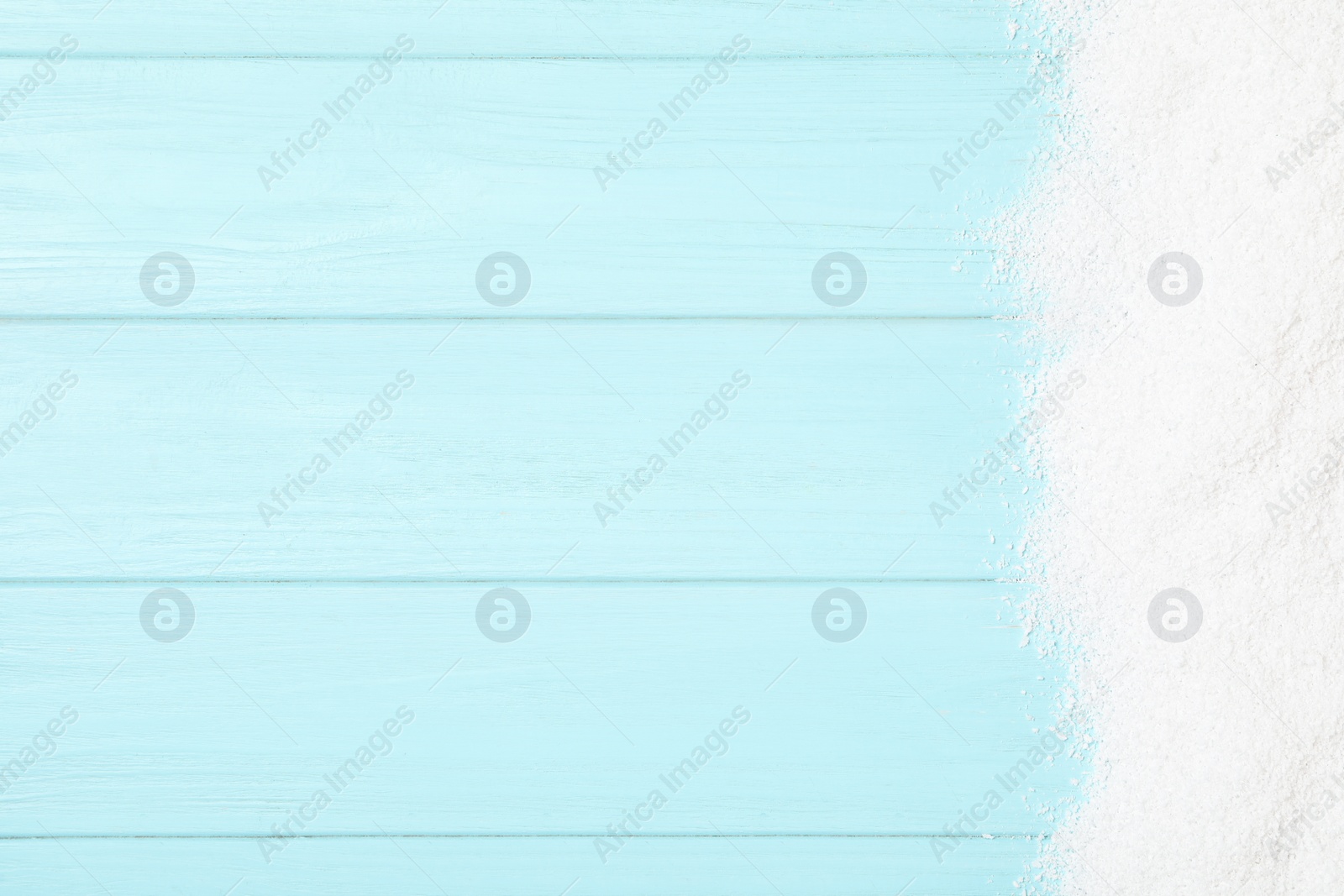 Artificial snow on light blue wooden background, top view with space for text. Christmas decor Photo of Artificial snow on light blue wooden background, top view with space for text. Christmas decor