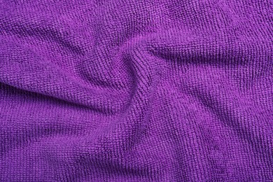 Crumpled purple microfiber cloth as background, closeup Photo of Crumpled purple microfiber cloth as background, closeup