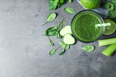 Green juice and fresh ingredients on grey table, flat lay. Space for text Photo of Green juice and fresh ingredients on grey table, flat lay. Space for text
