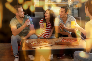 Group of friends having fun party with delicious pizza in cafe, bokeh effect Image of Group of friends having fun party with delicious pizza in cafe, bokeh effect