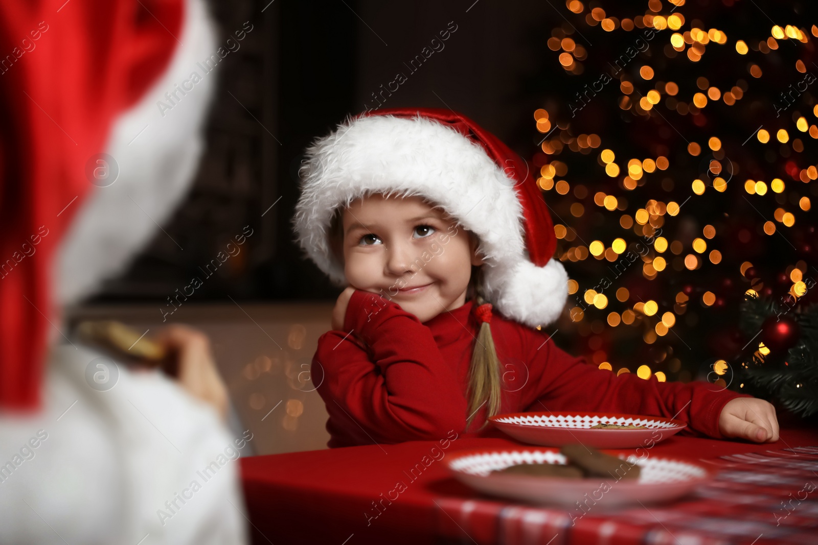 Cute little children at table in dining room. Christmas time Photo of Cute little children at table in dining room. Christmas time
