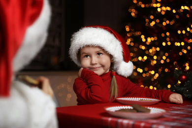 Cute little children at table in dining room. Christmas time Photo of Cute little children at table in dining room. Christmas time