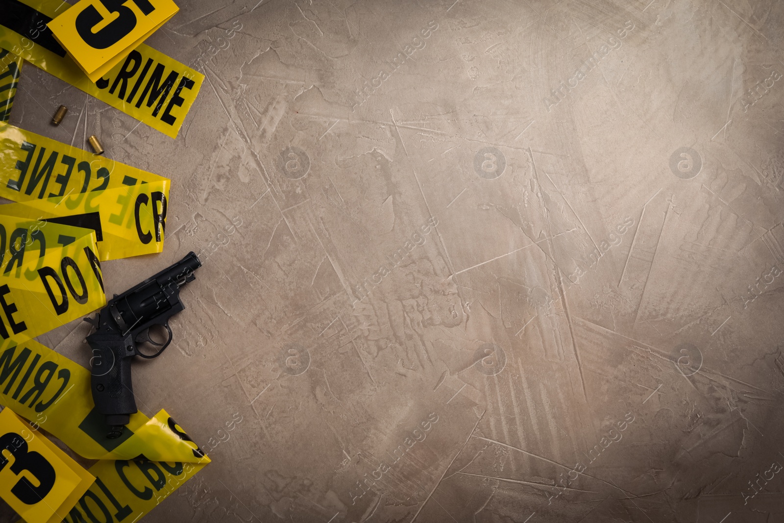 Flat lay with yellow tape, crime scene marker and gun on grey stone background. Space for text Photo of Flat lay with yellow tape, crime scene marker and gun on grey stone background. Space for text