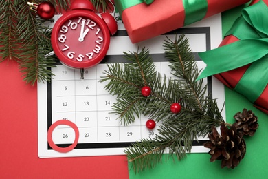 Flat lay composition with calendar and gifts on color background. Boxing day concept Photo of Flat lay composition with calendar and gifts on color background. Boxing day concept