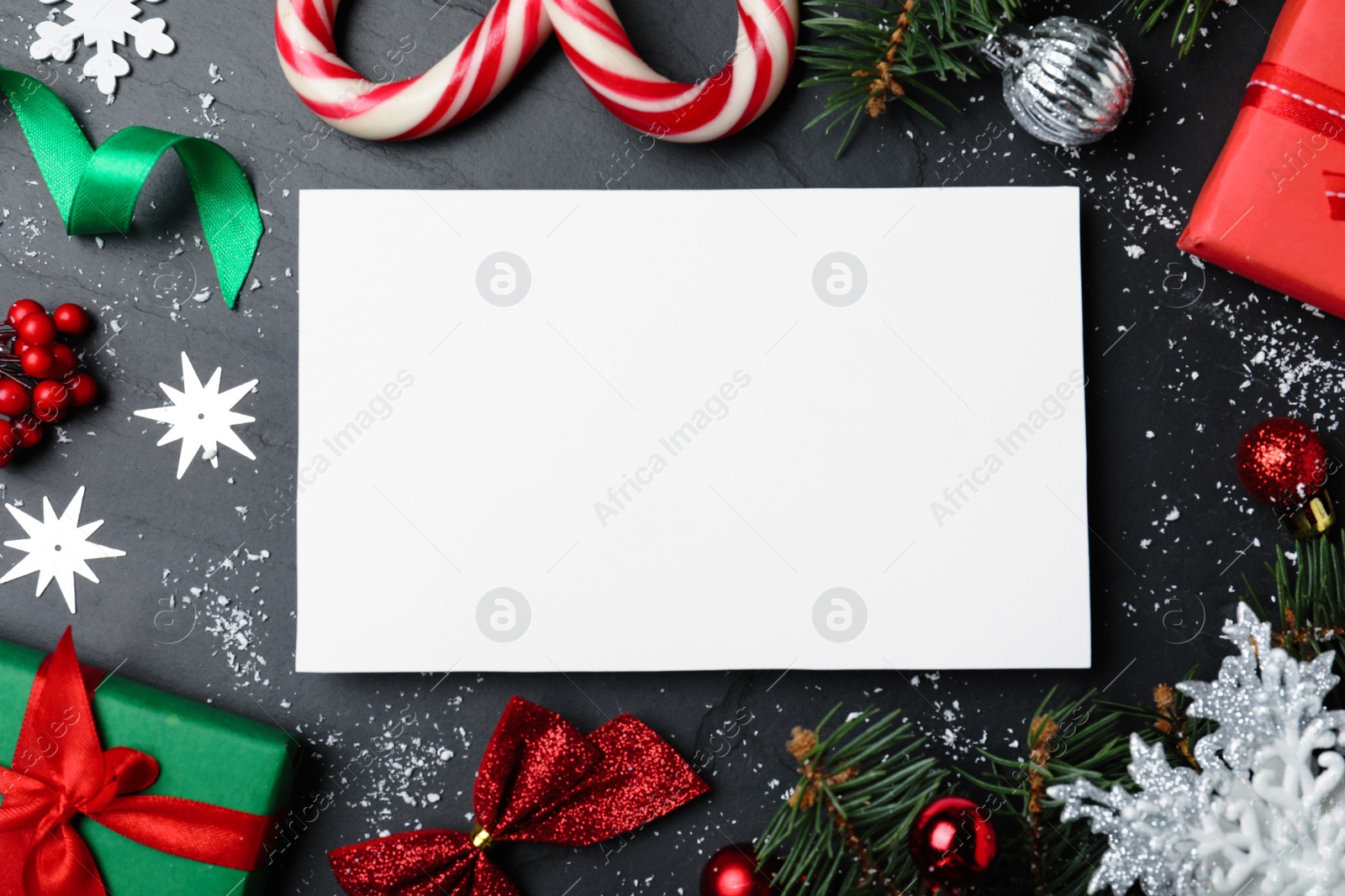 Flat lay composition with Christmas decor and blank card on black background. Space for text Photo of Flat lay composition with Christmas decor and blank card on black background. Space for text