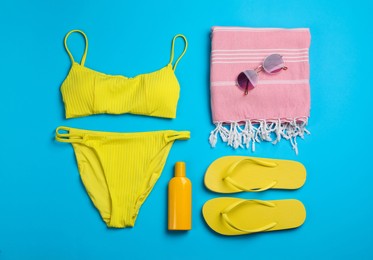 Flat lay composition with beach objects on light blue background Photo of Flat lay composition with beach objects on light blue background