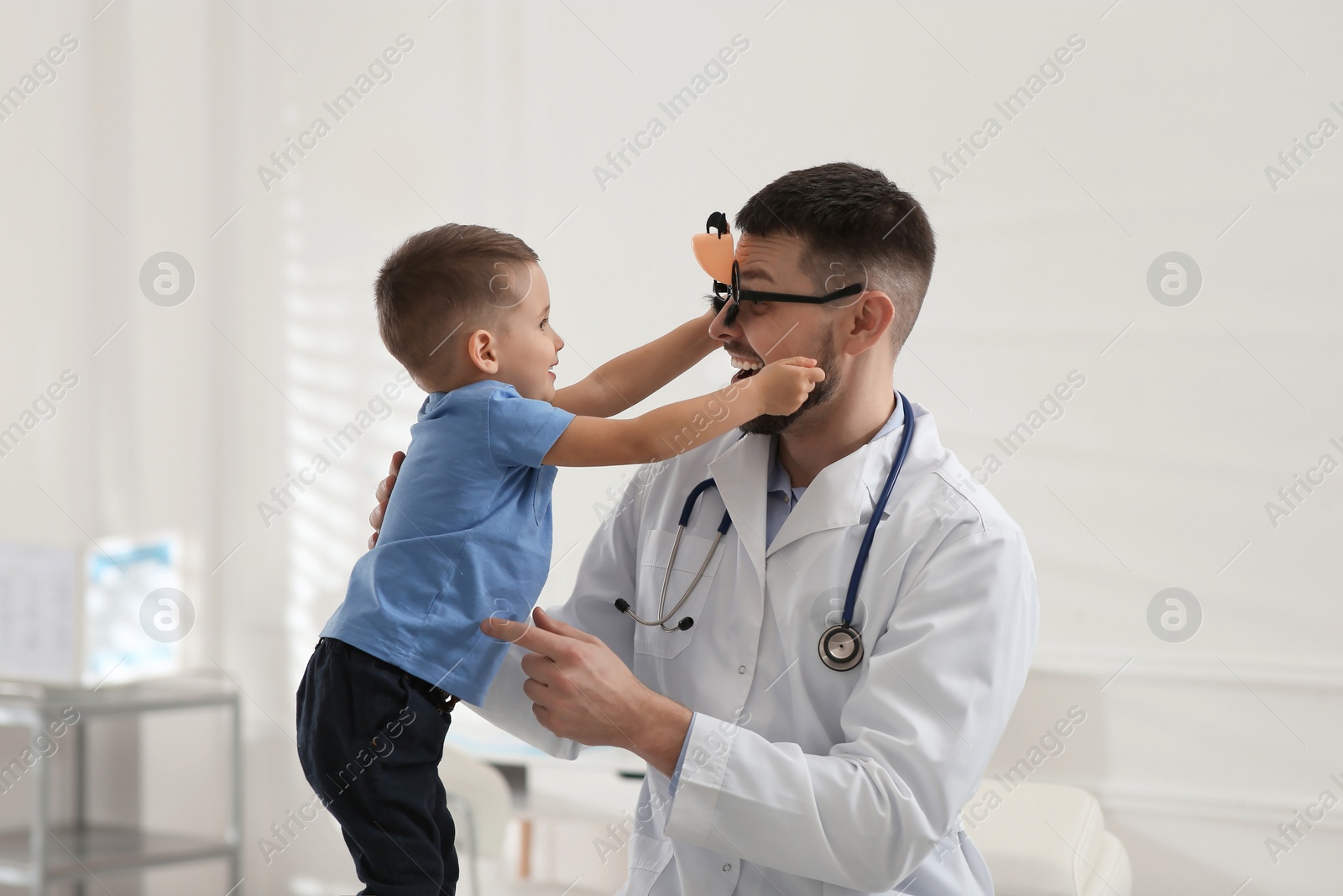 Pediatrician playing with little boy at hospital Photo of Pediatrician playing with little boy at hospital