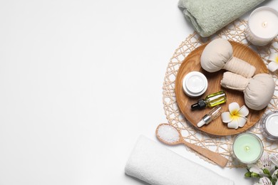 Flat lay composition with spa essentials on white background. Space for text Photo of Flat lay composition with spa essentials on white background. Space for text