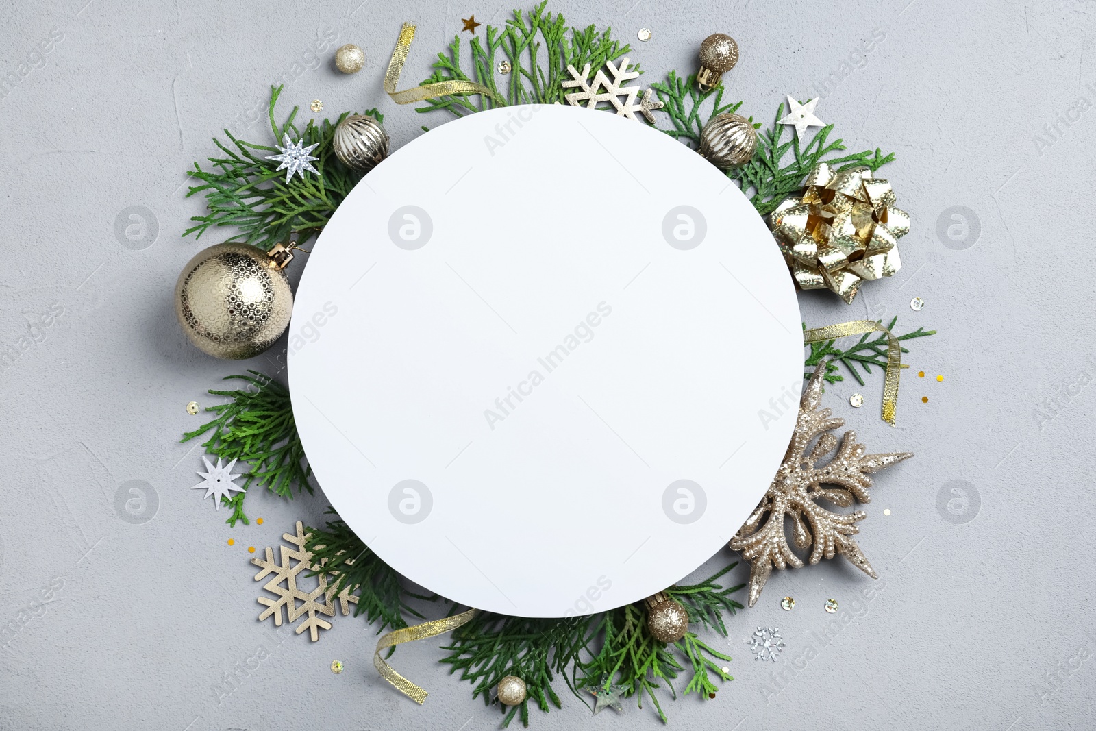 Flat lay composition with Christmas decor and blank card on light grey background. Space for text Photo of Flat lay composition with Christmas decor and blank card on light grey background. Space for text