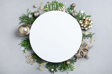 Photo of Flat lay composition with Christmas decor and blank card on light grey background. Space for text
