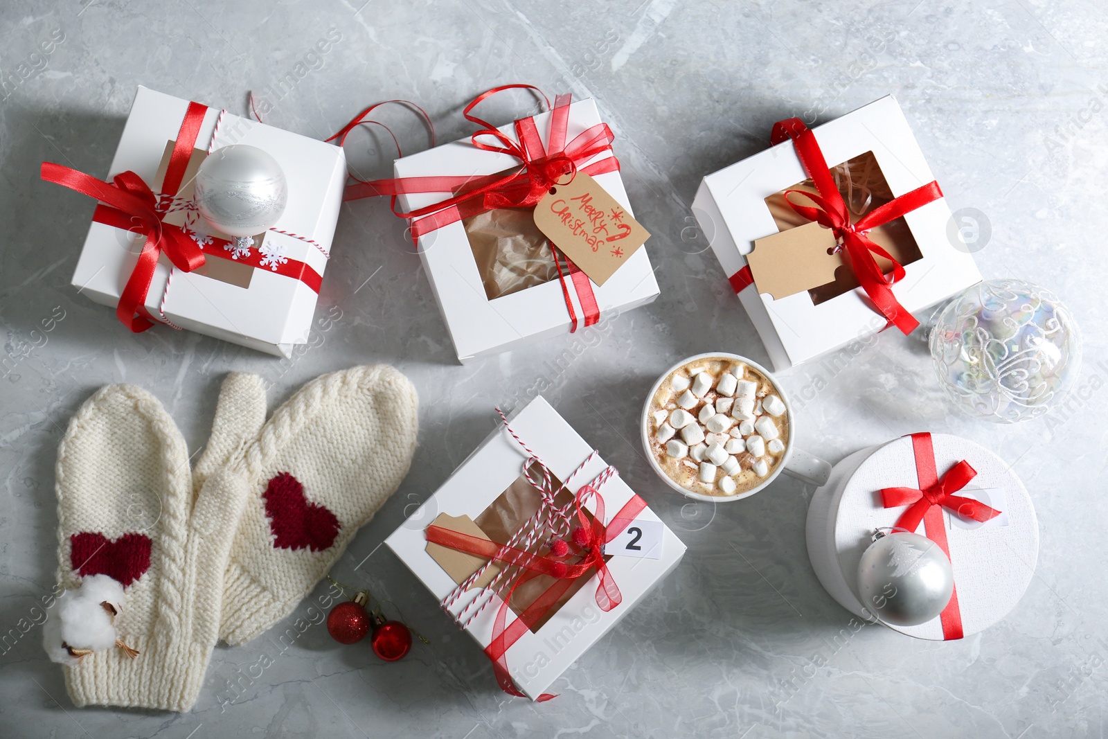 Flat lay composition with Christmas gifts, cup of marshmallow cocoa and festive decor on light grey marble table. Creating Advent calendar Photo of Flat lay composition with Christmas gifts, cup of marshmallow cocoa and festive decor on light grey marble table. Creating Advent calendar