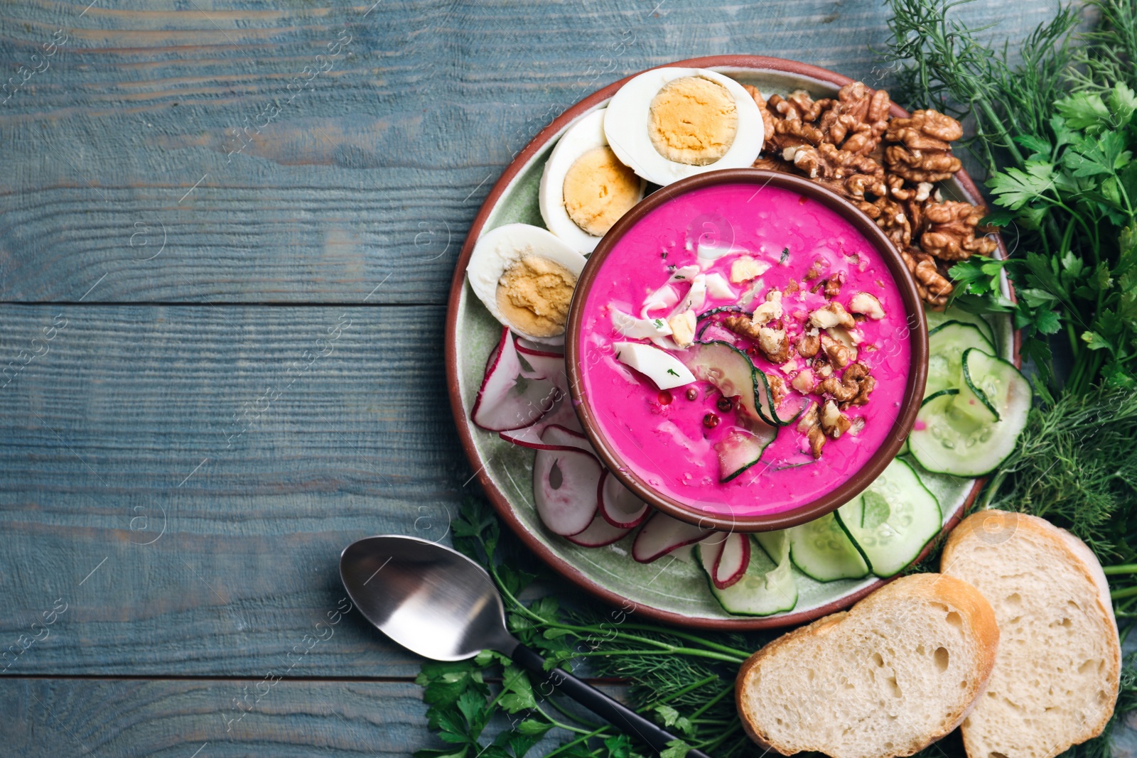 Delicious cold summer beet soup on blue wooden table, flat lay. Space for text Photo of Delicious cold summer beet soup on blue wooden table, flat lay. Space for text
