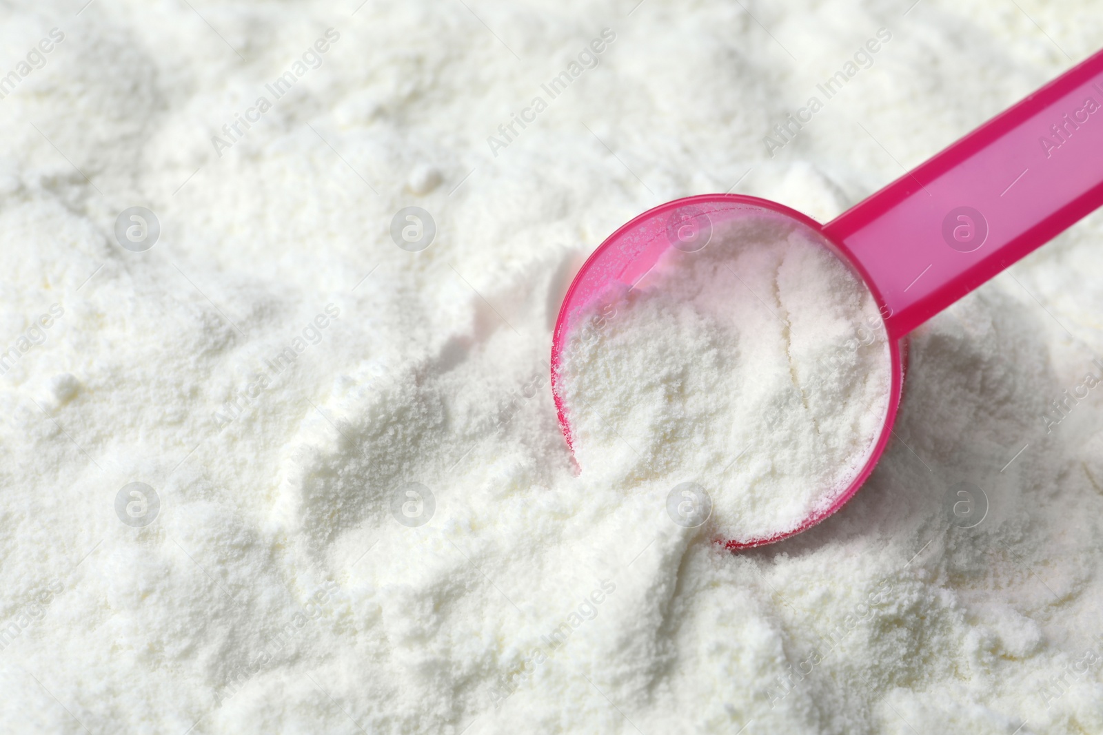 Powdered infant formula and scoop, closeup with space for text. Baby milk Photo of Powdered infant formula and scoop, closeup with space for text. Baby milk