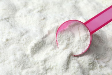 Powdered infant formula and scoop, closeup with space for text. Baby milk Photo of Powdered infant formula and scoop, closeup with space for text. Baby milk