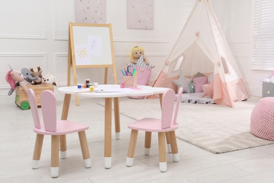 Cute child's room interior with toys, modern furniture and play tent Photo of Cute child's room interior with toys, modern furniture and play tent