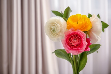Beautiful ranunculus flowers on blurred background Photo of Beautiful ranunculus flowers on blurred background
