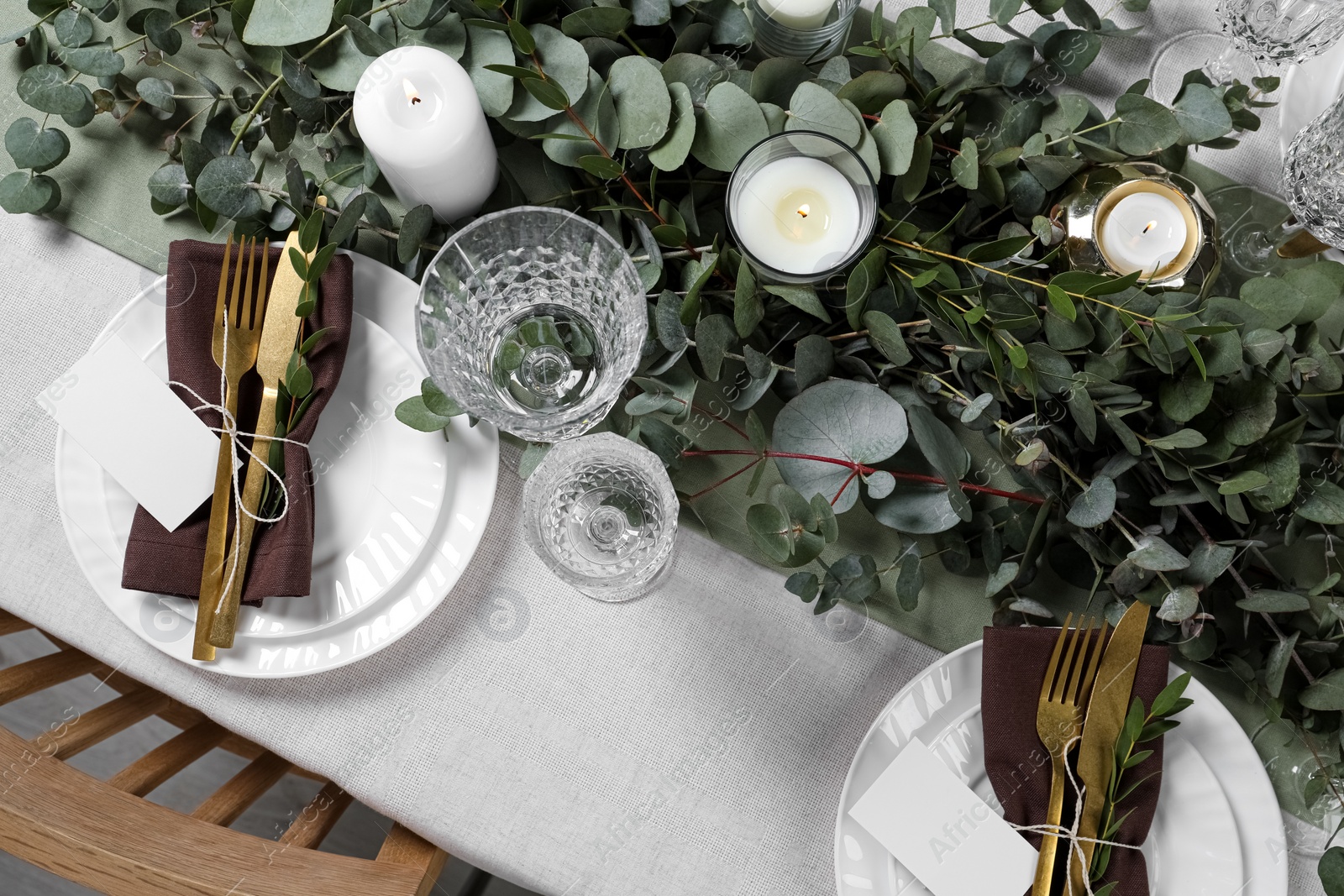 Luxury table setting with beautiful decor and blank cards. Festive dinner Photo of Luxury table setting with beautiful decor and blank cards. Festive dinner