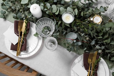 Luxury table setting with beautiful decor and blank cards. Festive dinner Photo of Luxury table setting with beautiful decor and blank cards. Festive dinner