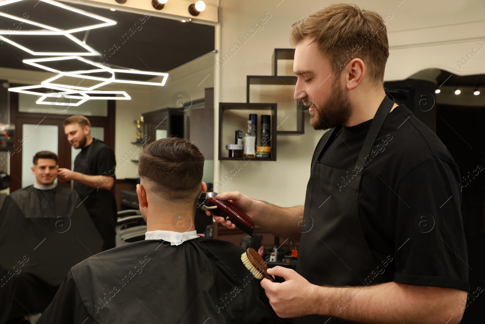 Professional hairdresser making stylish haircut in salon Photo of Professional hairdresser making stylish haircut in salon