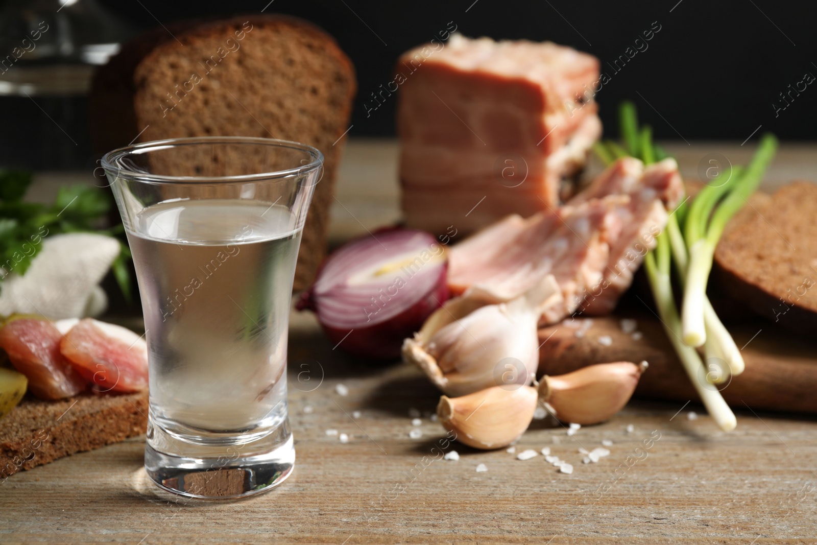 Cold Russian vodka with snacks on wooden table, closeup Photo of Cold Russian vodka with snacks on wooden table, closeup