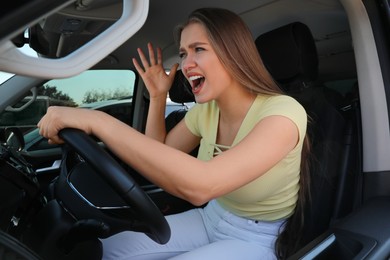 Emotional woman in car. Aggressive driving behavior Photo of Emotional woman in car. Aggressive driving behavior