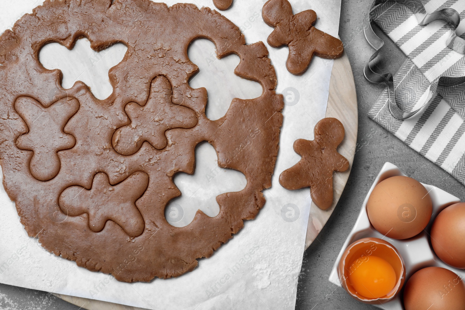 Flat lay composition with homemade gingerbread man cookies on grey table Photo of Flat lay composition with homemade gingerbread man cookies on grey table