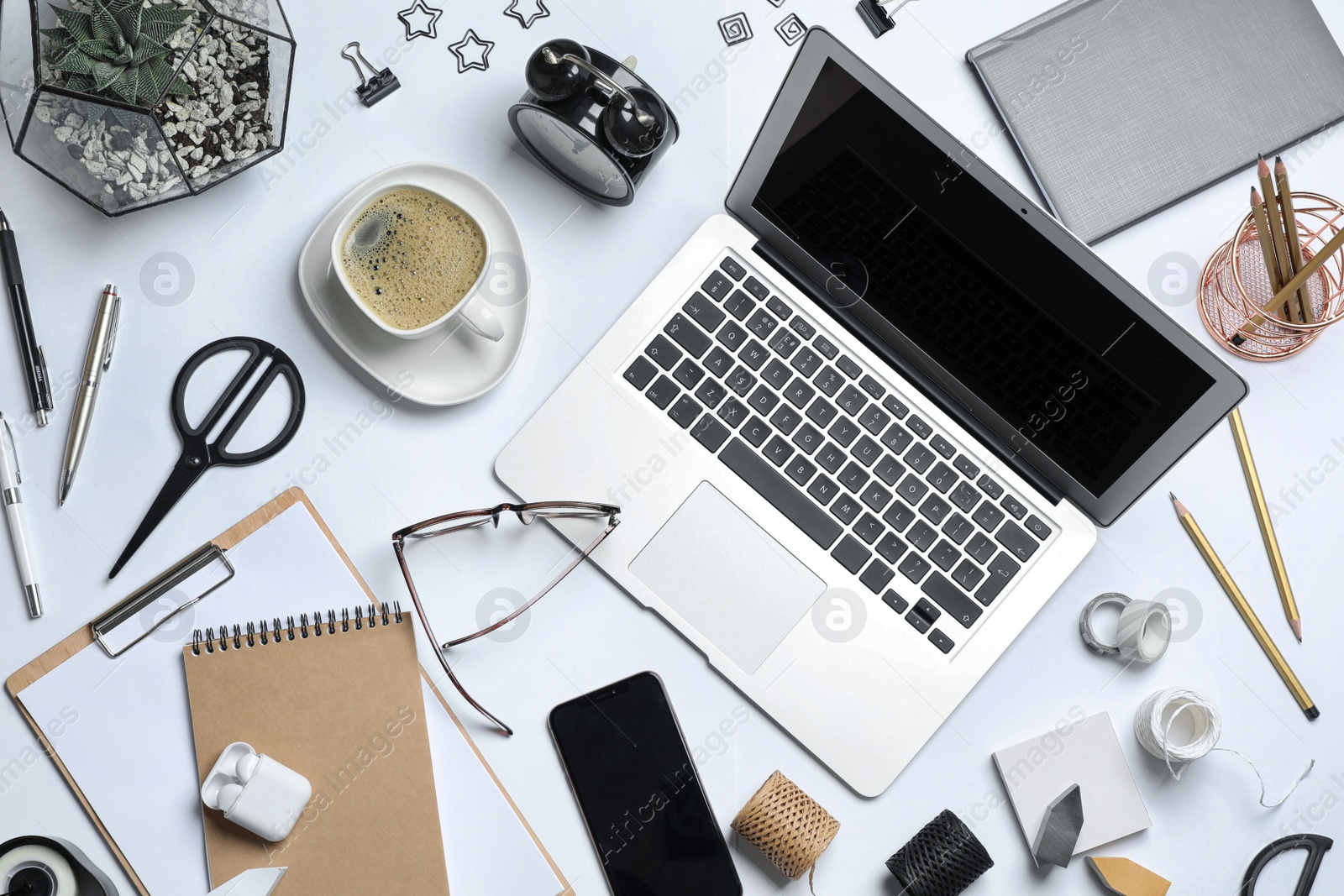 Photo of Flat lay composition with laptop, smartphone and stationery on white table. Designer's workplace