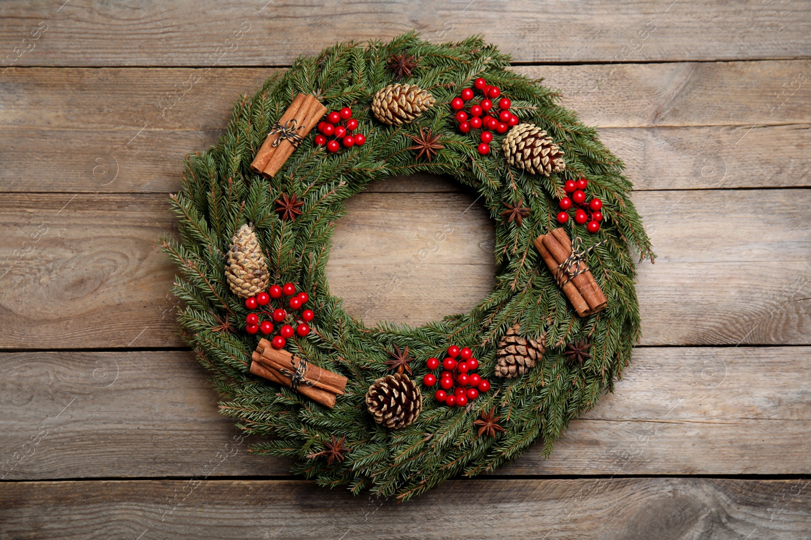 Photo of Beautiful Christmas wreath on wooden background, top view